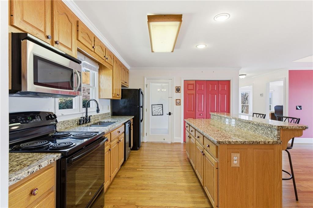 1015 Eagle Ridge Road Dawsonville, GA 30534 - Photo 9 of 64 a kitchen with stainless steel appliances granite countertop a stove a sink and a microwave