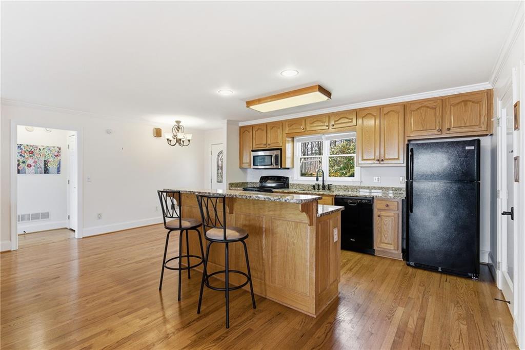 1015 Eagle Ridge Road Dawsonville, GA 30534 - Photo 10 of 64 a kitchen with stainless steel appliances granite countertop a refrigerator a stove a sink dishwasher with a dining table and chairs