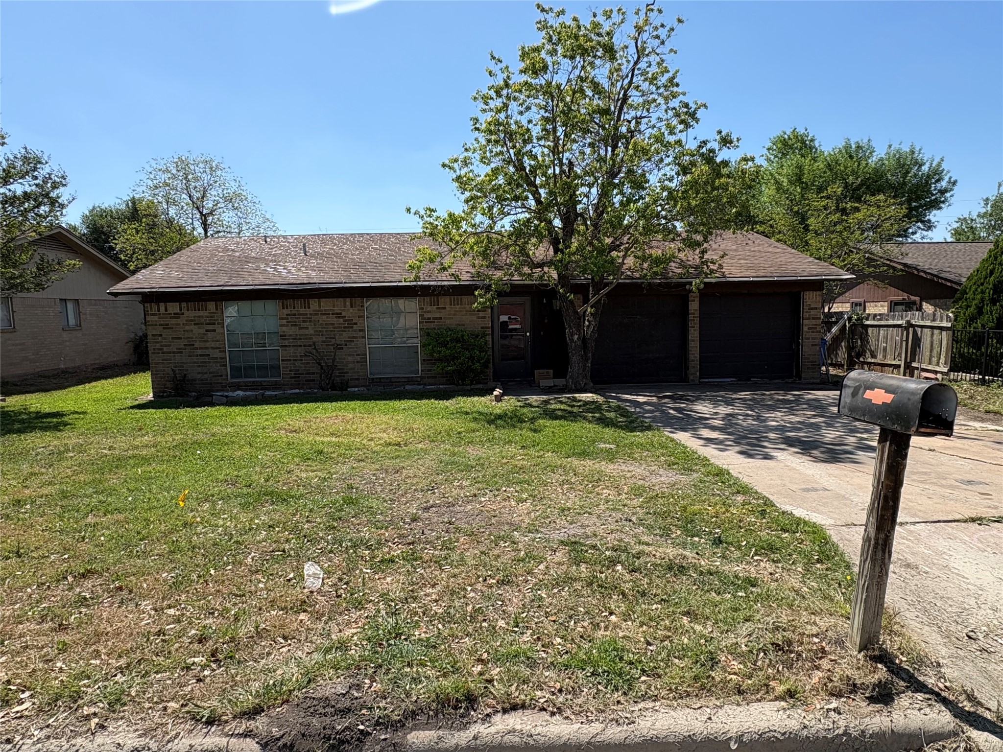 a front view of house with yard and trees