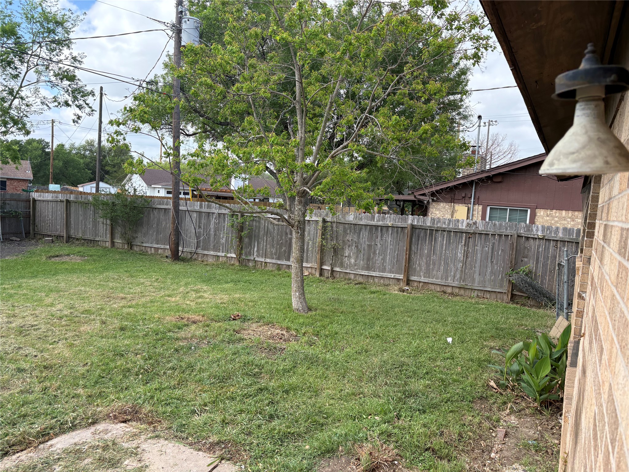 709 Drake Lane Taylor, TX 76574 - Photo 14 of 17 a view of a backyard with a trees and wooden fence