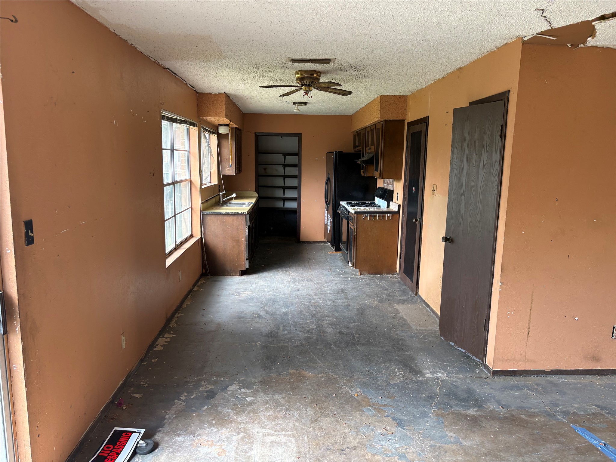 709 Drake Lane Taylor, TX 76574 - Photo 4 of 17 a view of a kitchen with a sink and a refrigerator