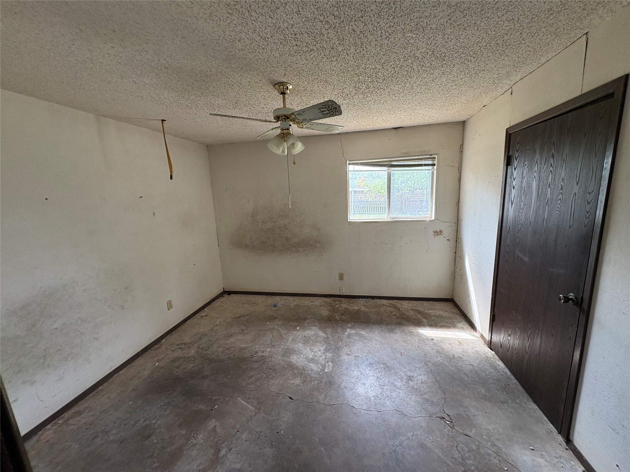 709 Drake Lane Taylor, TX 76574 - Photo 9 of 17 an empty room with windows and fan