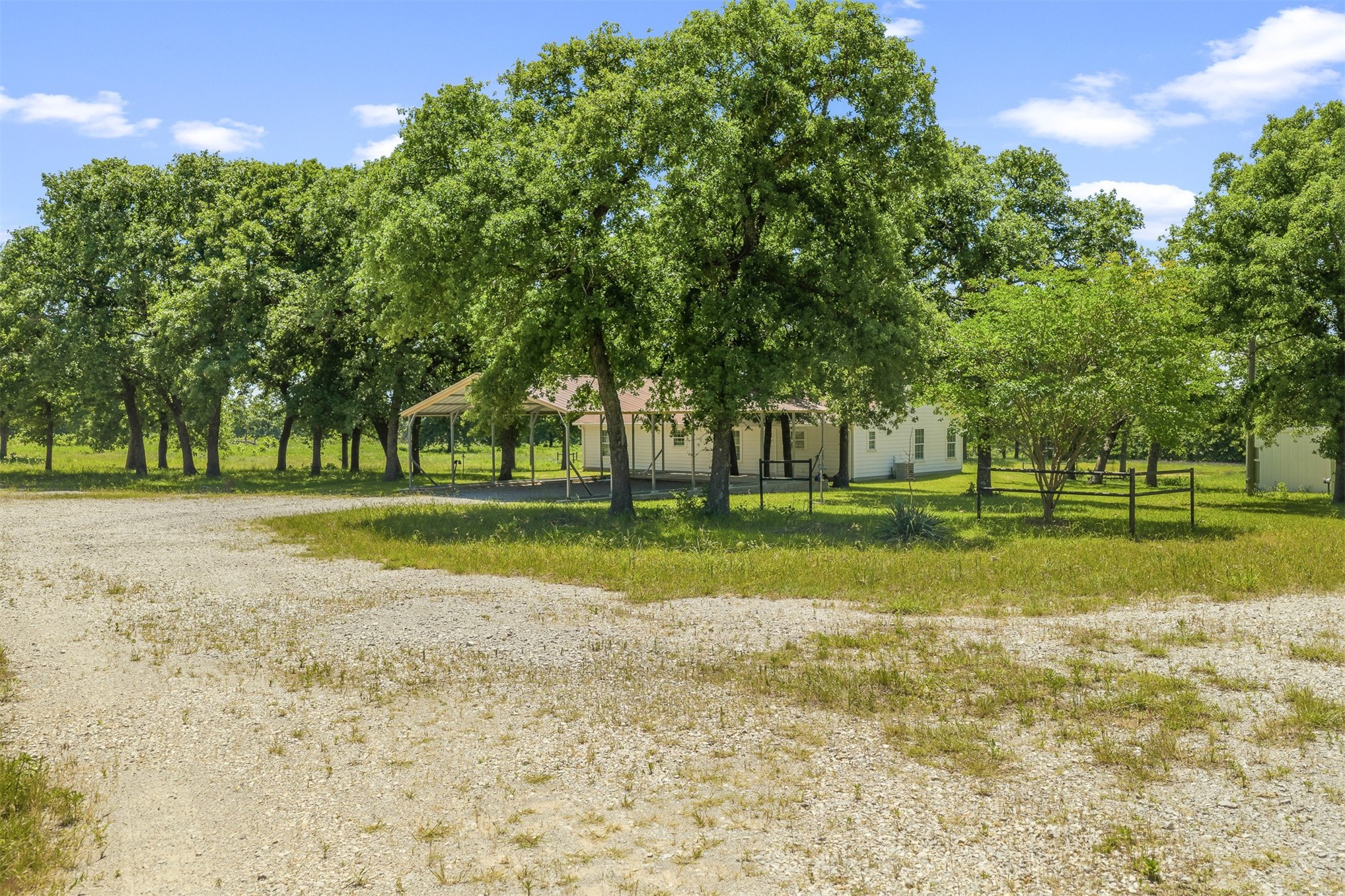 831 Barrons Ridge Wilson, OK 73463 - Photo 31 of 47 Expansive gravel driveway leading to a residence with a covered porch