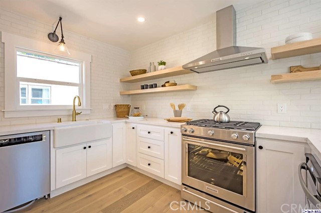 1240 Neola Street Eagle Rock, CA 90041 - Photo 14 of 19 a kitchen with cabinets stainless steel appliances and wooden floor