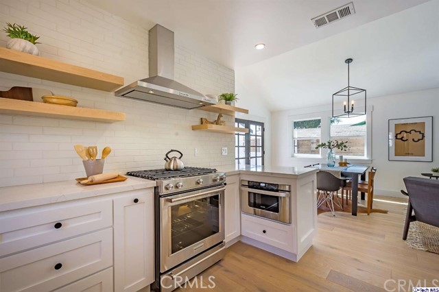 1240 Neola Street Eagle Rock, CA 90041 - Photo 16 of 19 a kitchen with stainless steel appliances granite countertop a stove a sink and a refrigerator