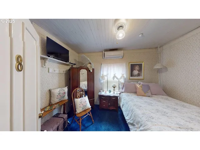 a living room with a bed furniture and a window