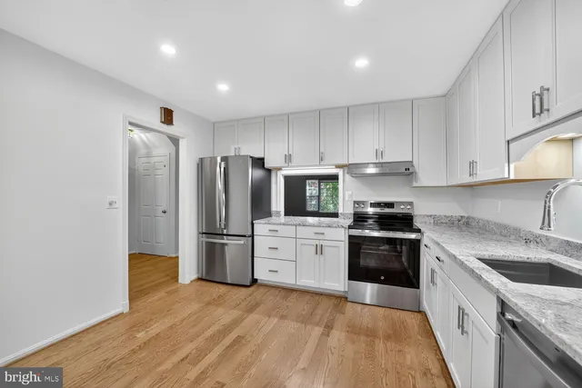a kitchen with a refrigerator stove and sink
