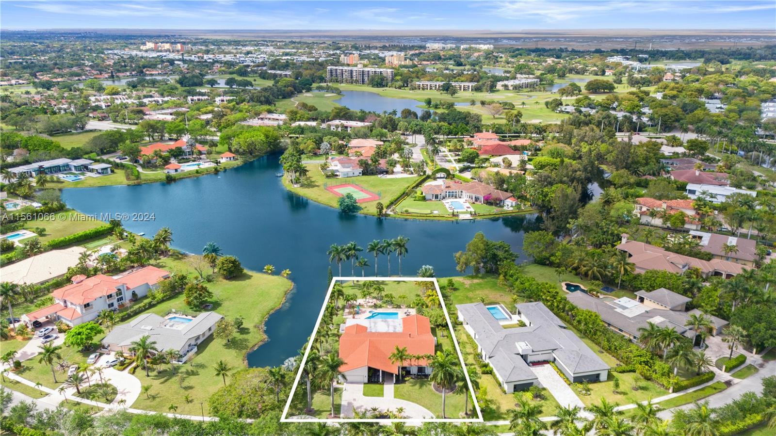 an aerial view of residential houses with outdoor space and swimming pool