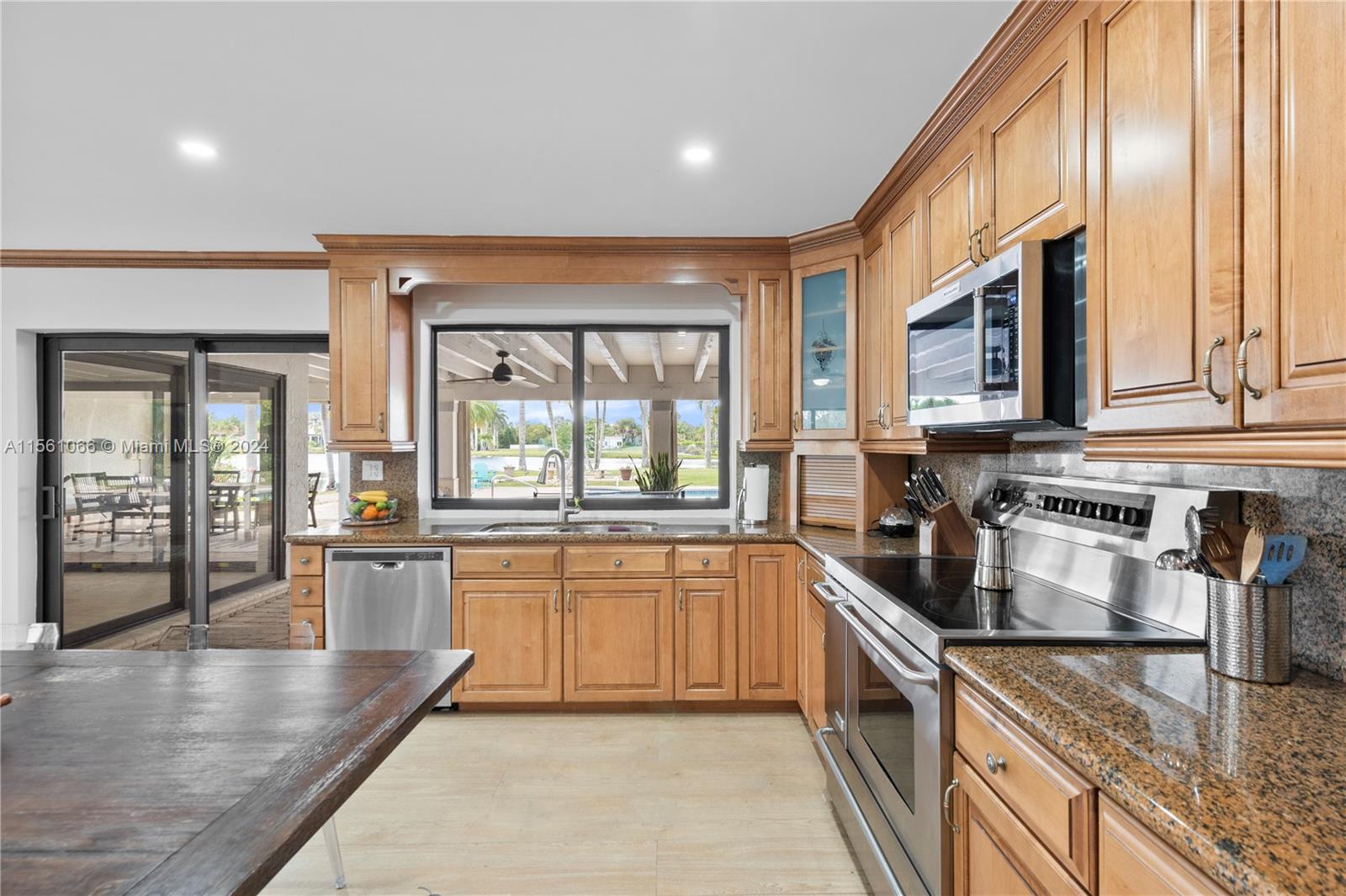 501 Ranch Road Weston, FL 33326 - Photo 13 of 50 a large kitchen with granite countertop a large window and a counter space