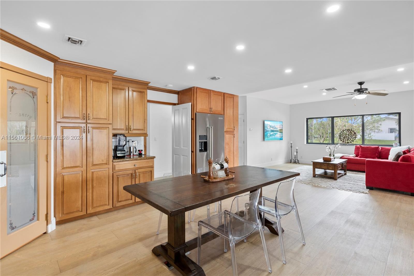 501 Ranch Road Weston, FL 33326 - Photo 14 of 50 a kitchen with sink cabinets dining table and chairs