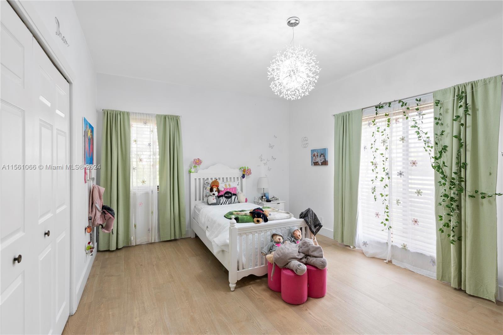 501 Ranch Road Weston, FL 33326 - Photo 21 of 50 a bedroom with furniture and a chandelier