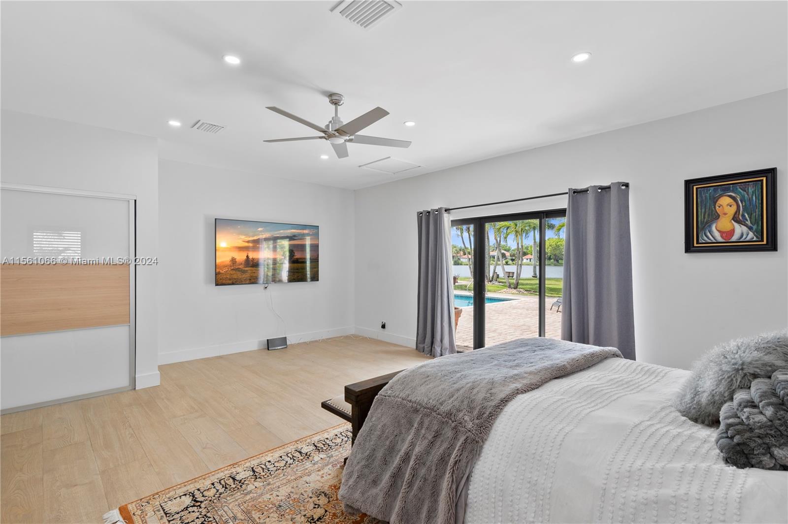 501 Ranch Road Weston, FL 33326 - Photo 26 of 50 a bedroom with a large bed and a chandelier