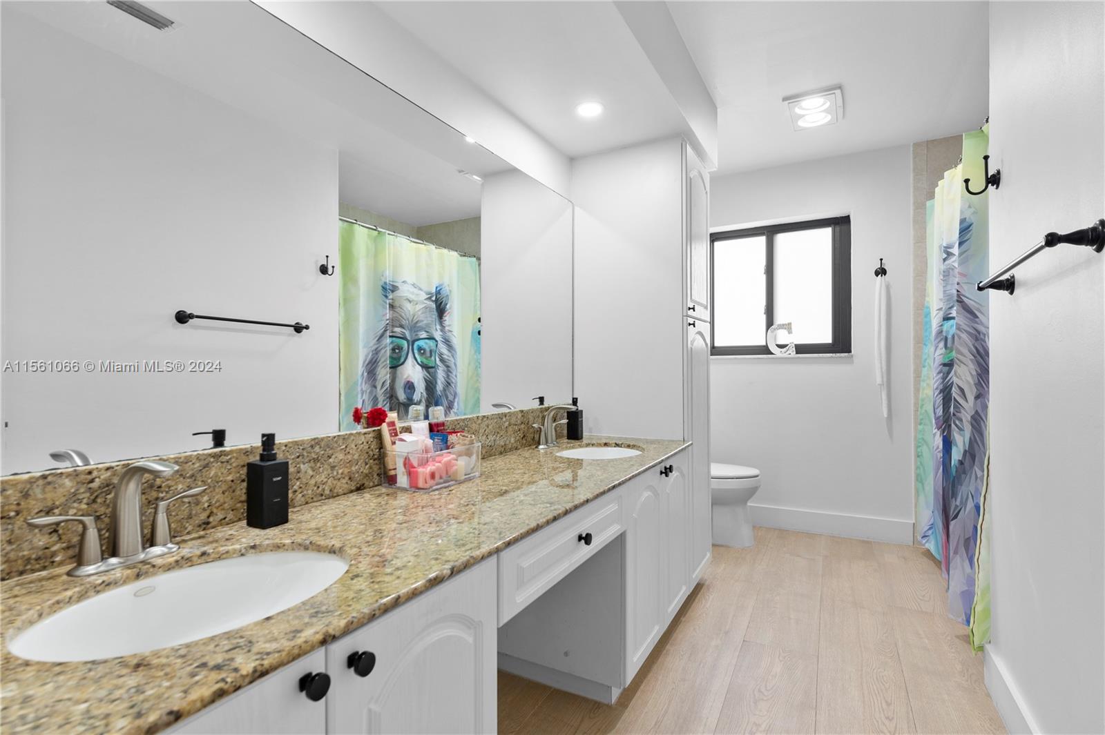 501 Ranch Road Weston, FL 33326 - Photo 29 of 50 a bathroom with a granite countertop double vanity sink a mirror and a toilet