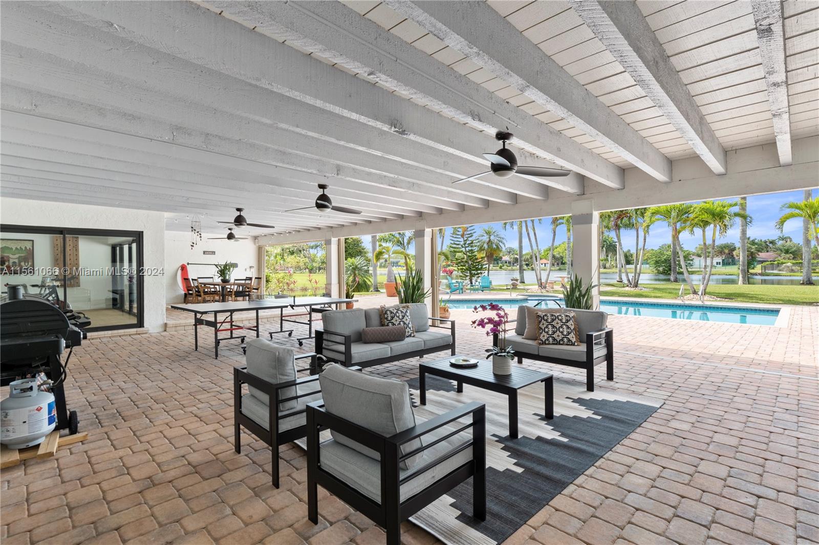501 Ranch Road Weston, FL 33326 - Photo 40 of 50 a living room with patio furniture and a large window