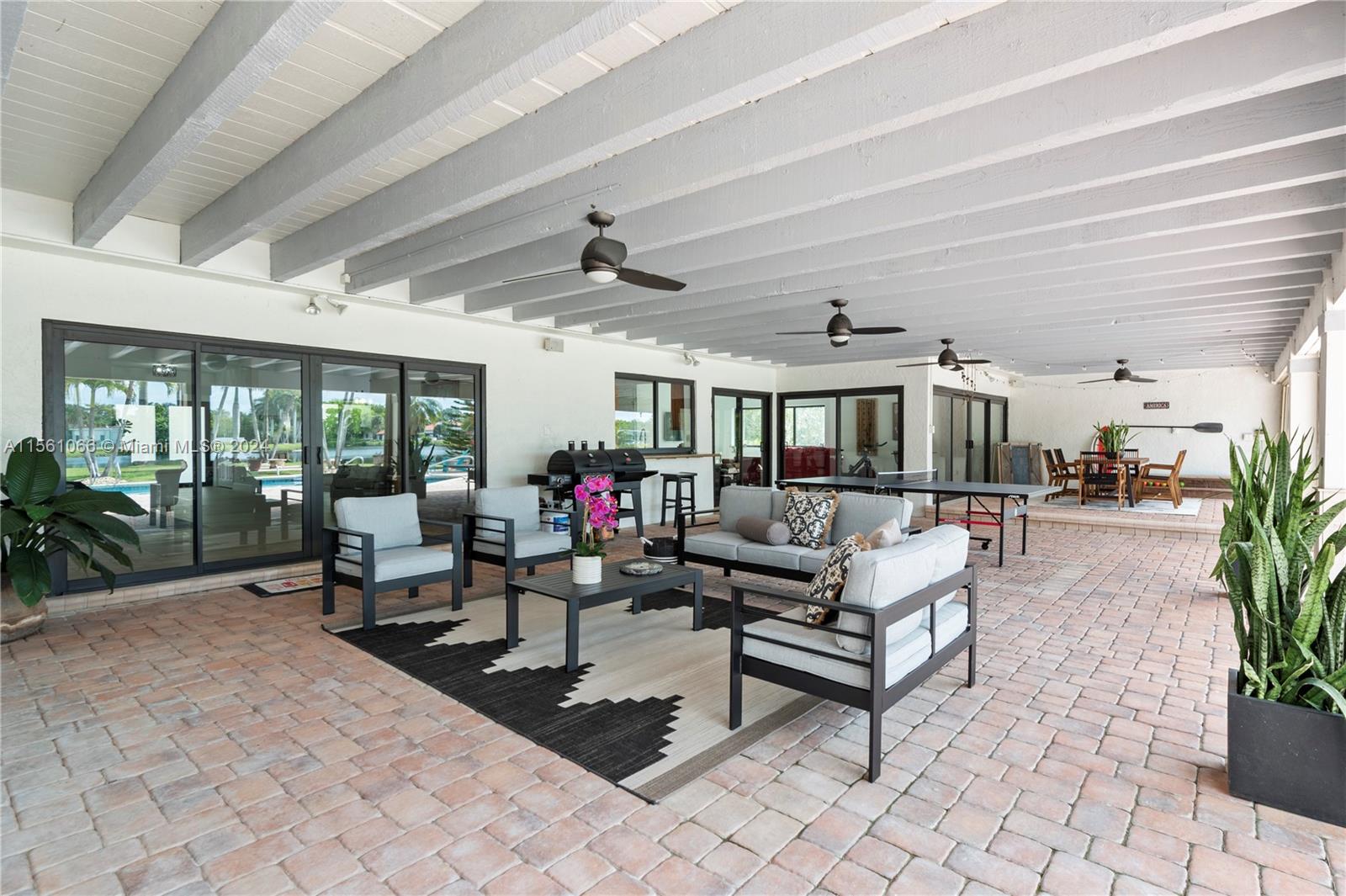 501 Ranch Road Weston, FL 33326 - Photo 41 of 50 a living room with patio furniture and a potted plant