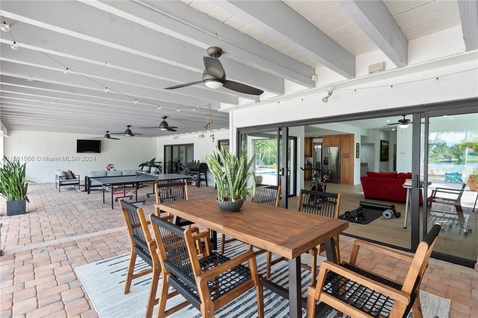 501 Ranch Road Weston, FL 33326 - Photo 43 of 50 a dinning table and chairs in a patio