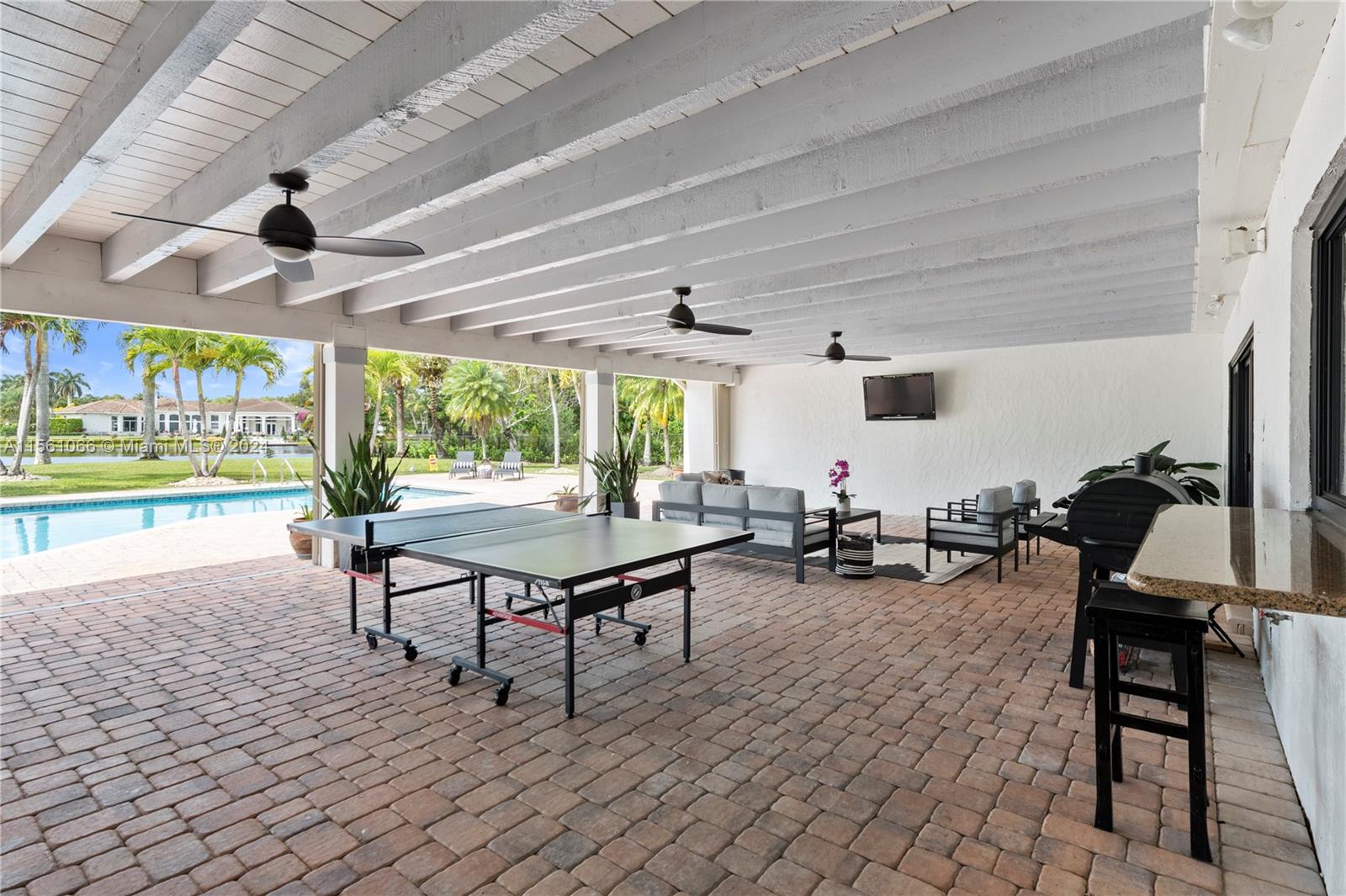 501 Ranch Road Weston, FL 33326 - Photo 44 of 50 a view of a patio with a table and chairs
