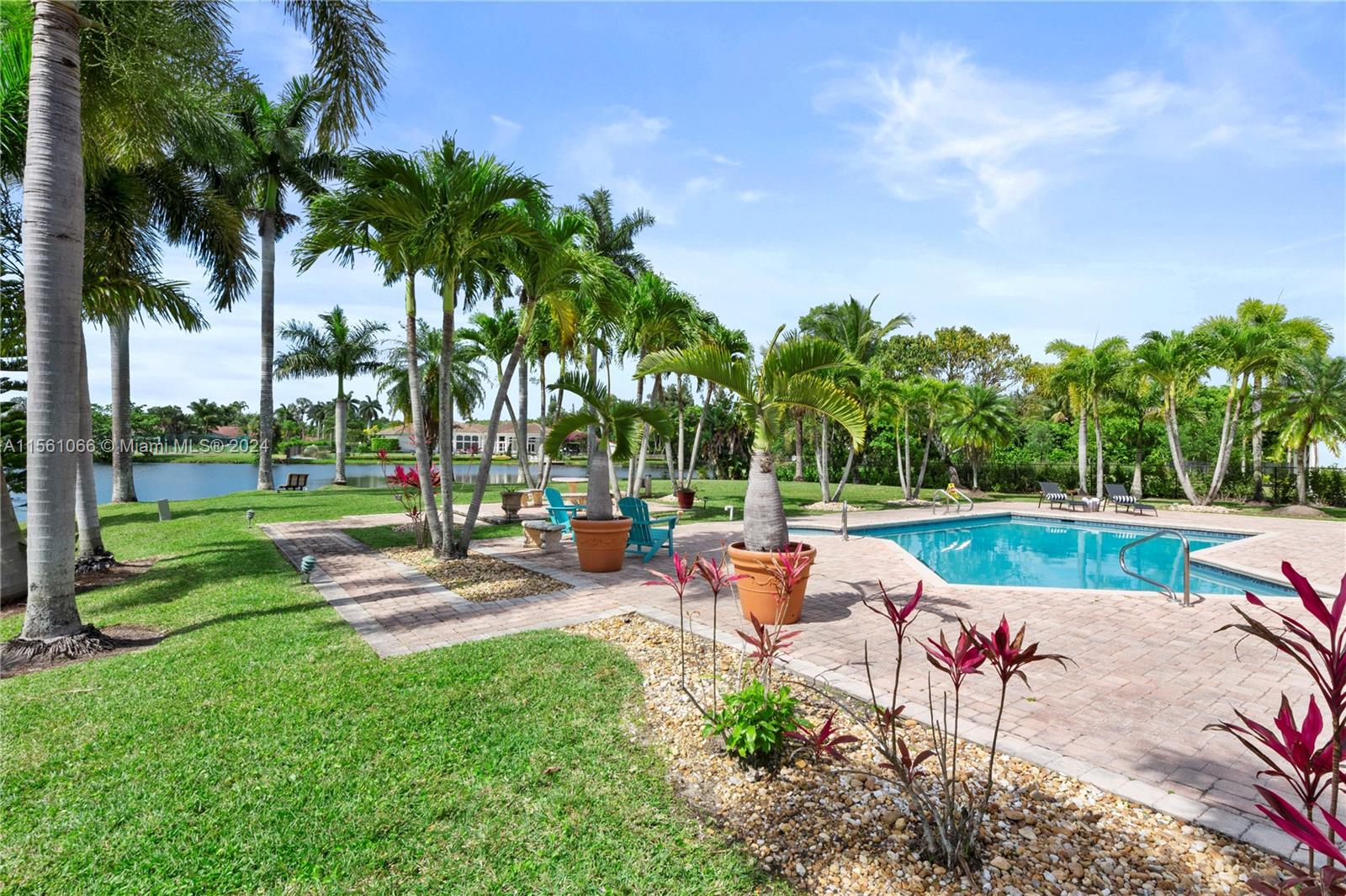 501 Ranch Road Weston, FL 33326 - Photo 47 of 50 a view of a swimming pool and lounge chairs in the garden