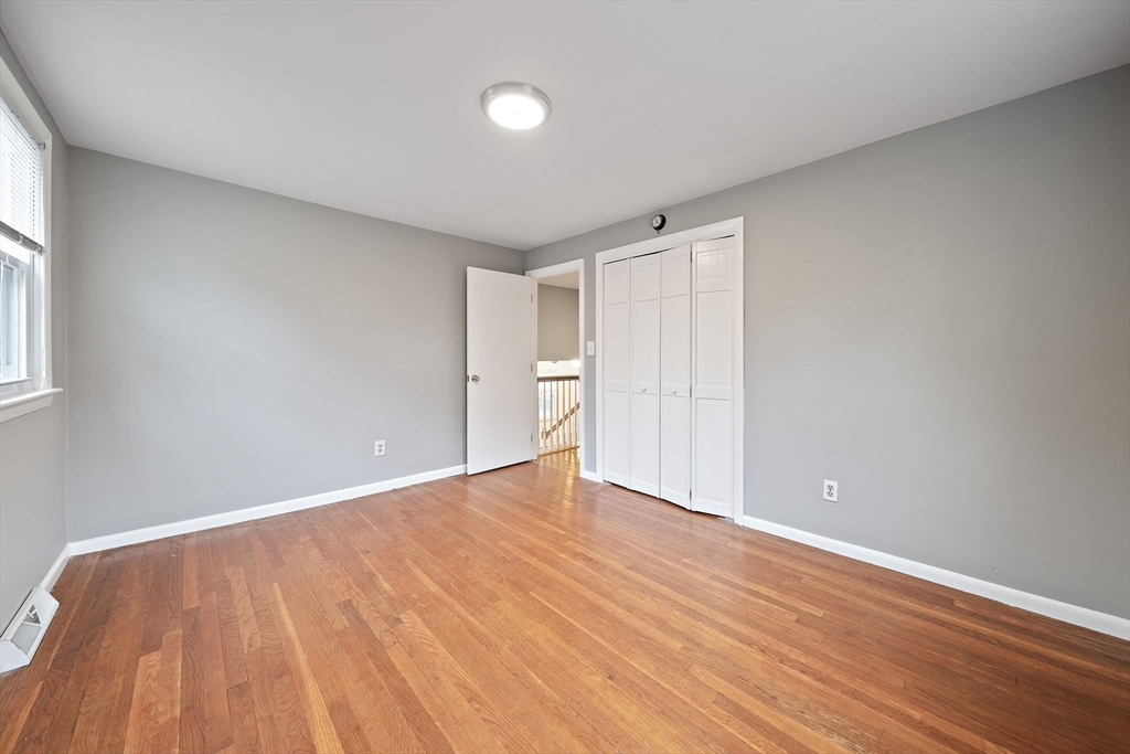 12 Stellar Road Braintree, MA 02184 - Photo 13 of 25 a view of an empty room with wooden floor and a window