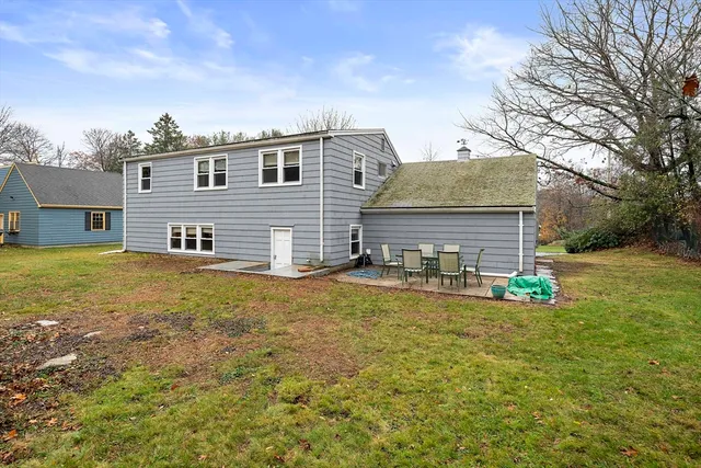 a view of a house with pool and chairs