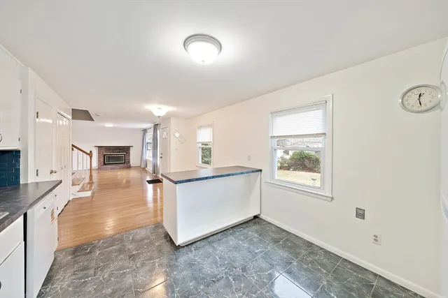 a view of a living room hardwood floor and a kitchen