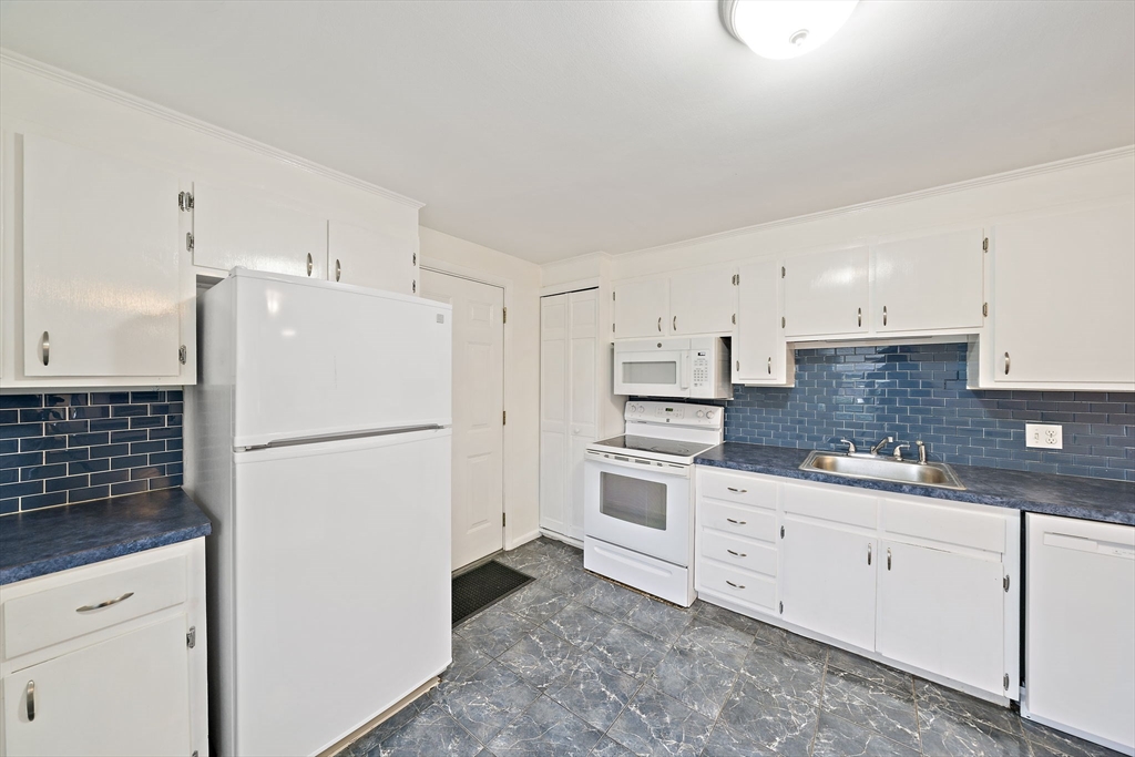 12 Stellar Road Braintree, MA 02184 - Photo 7 of 25 a white refrigerator freezer sitting inside of a kitchen