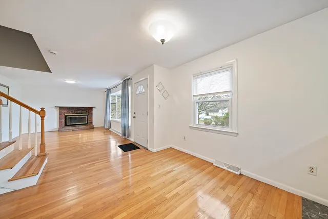a view of a room with wooden floor and window