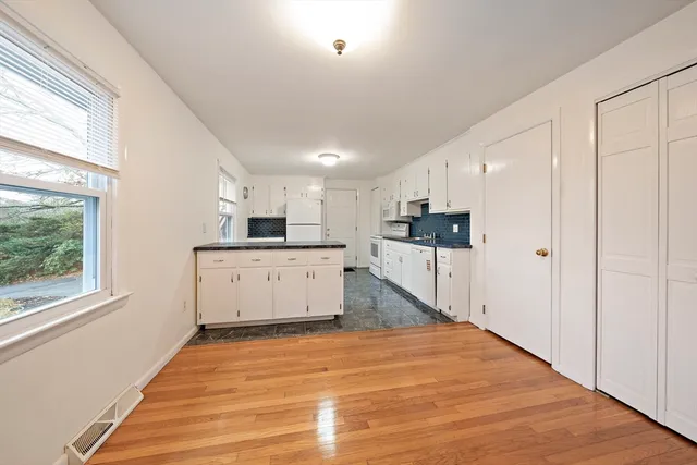 a view of kitchen with cabinets and wooden floor