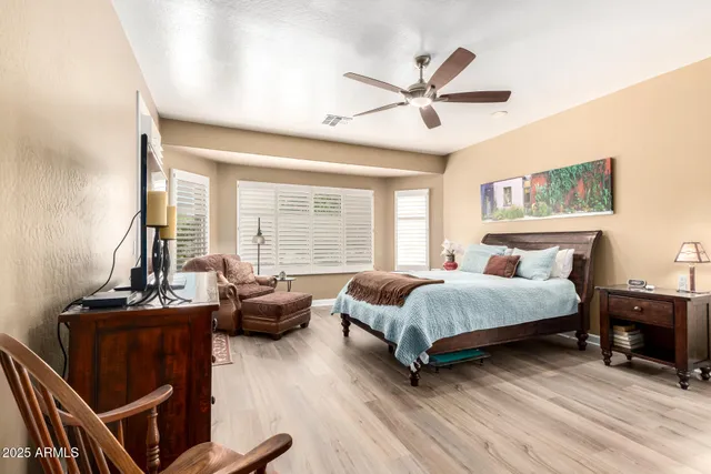 a bedroom with a bed and a television