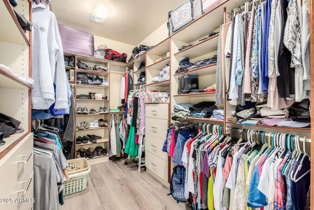 a bedroom with a bed lamp and a window
