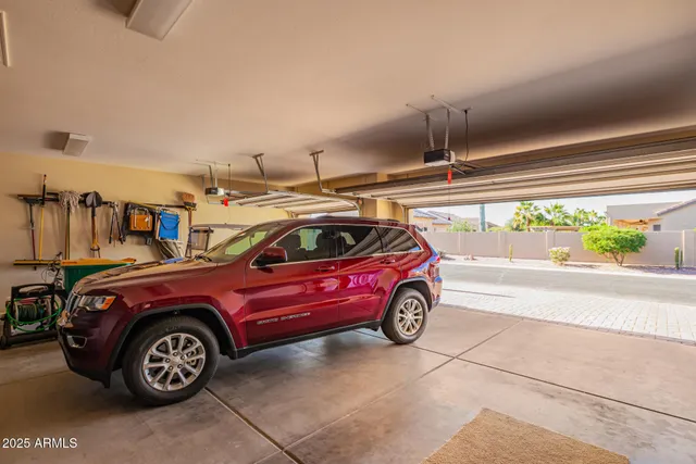 a view of a white house with a fountain and a yard