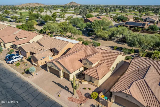 an aerial view of a house with a yard