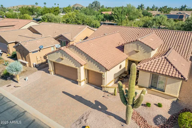 a view of a house with backyard and sitting area