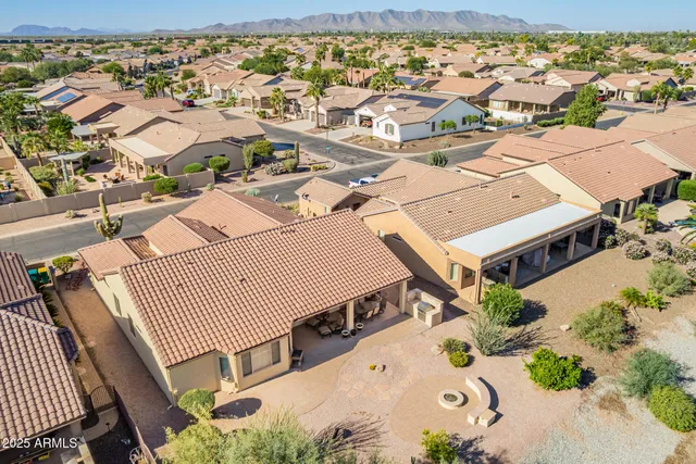 an aerial view of a house with a yard