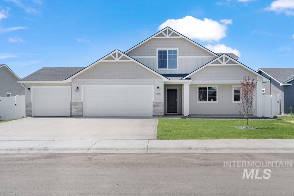 1355 Crescent Street Weiser, ID 83672 - Photo 29 of 31 Craftsman house featuring driveway, an attached garage, and stone siding