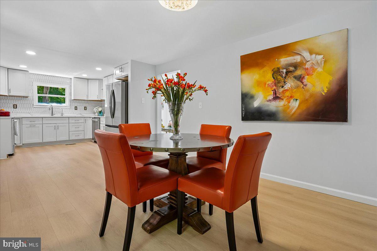523 Widewater Road Stafford, VA 22554 - Photo 15 of 57 a dining room with furniture potted plants and wooden floor