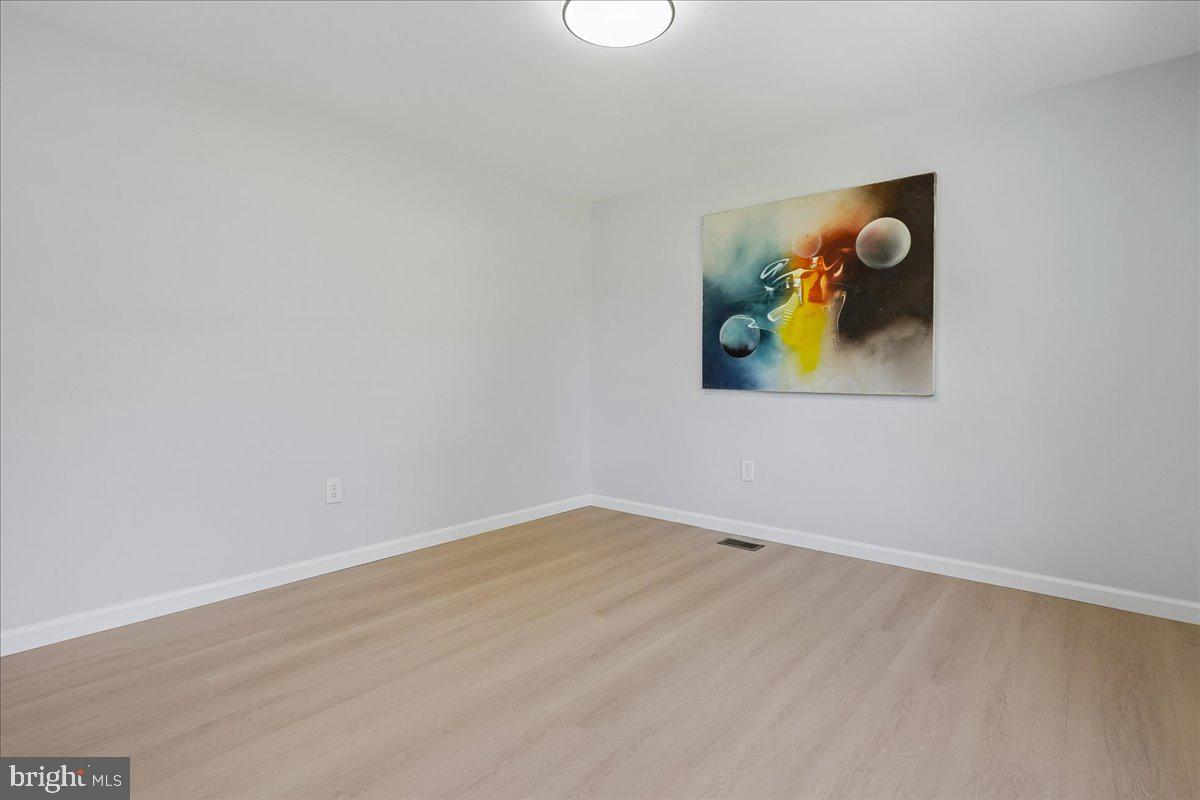 523 Widewater Road Stafford, VA 22554 - Photo 25 of 57 an empty room with a painting and lamp on th wall