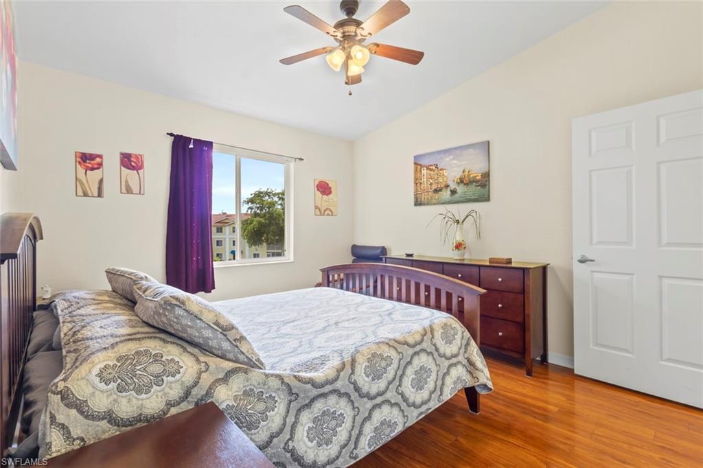 8288 Key Royal Lane, Unit 1435 Naples, FL 34119 - Photo 14 of 26 a bedroom with a bed and a window