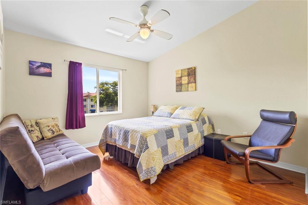8288 Key Royal Lane, Unit 1435 Naples, FL 34119 - Photo 17 of 26 a bedroom with a bed couch and window