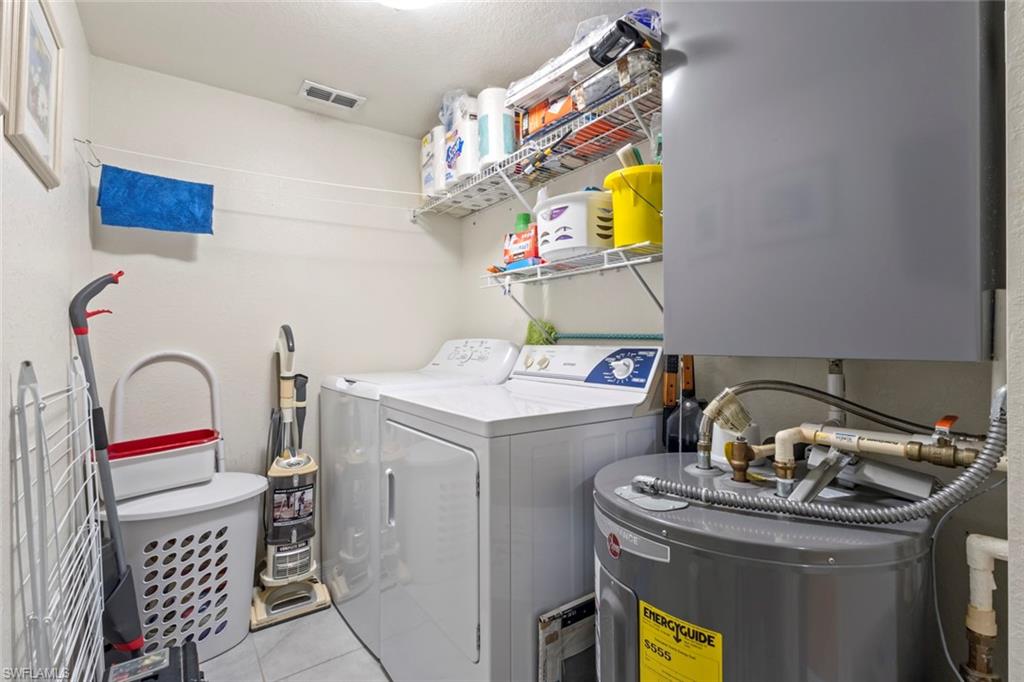 8288 Key Royal Lane, Unit 1435 Naples, FL 34119 - Photo 19 of 26 a utility room with dryer and washer