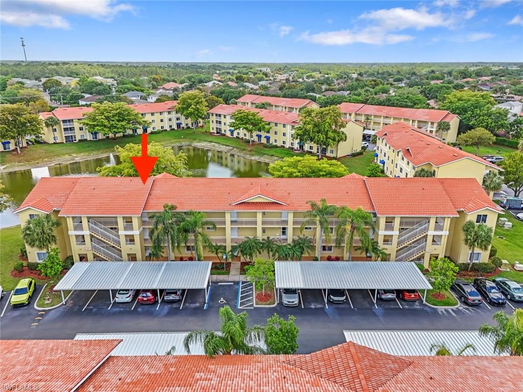 8288 Key Royal Lane, Unit 1435 Naples, FL 34119 - Photo 2 of 26 an aerial view of house with yard swimming pool and outdoor seating