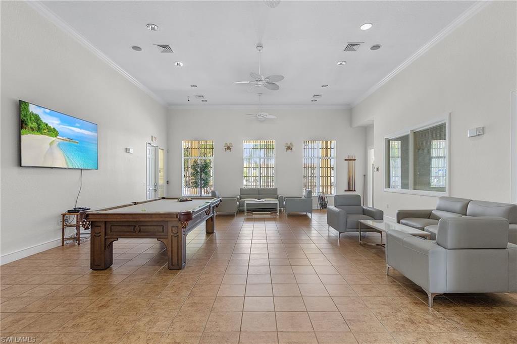 8288 Key Royal Lane, Unit 1435 Naples, FL 34119 - Photo 22 of 26 a living room with furniture and a large window