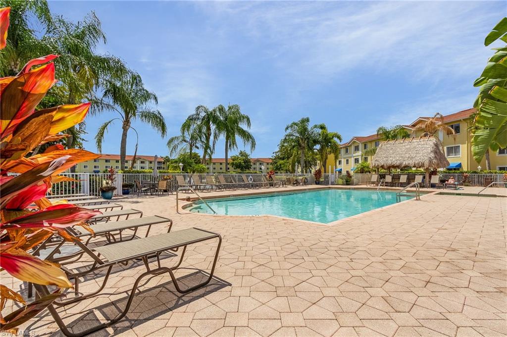 8288 Key Royal Lane, Unit 1435 Naples, FL 34119 - Photo 25 of 26 a view of swimming pool with outdoor seating and plants