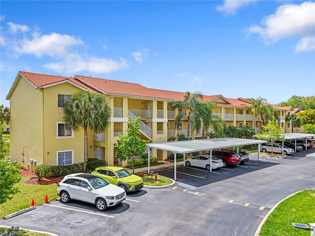 8288 Key Royal Lane, Unit 1435 Naples, FL 34119 - Photo 3 of 26 a car parked in front of a building