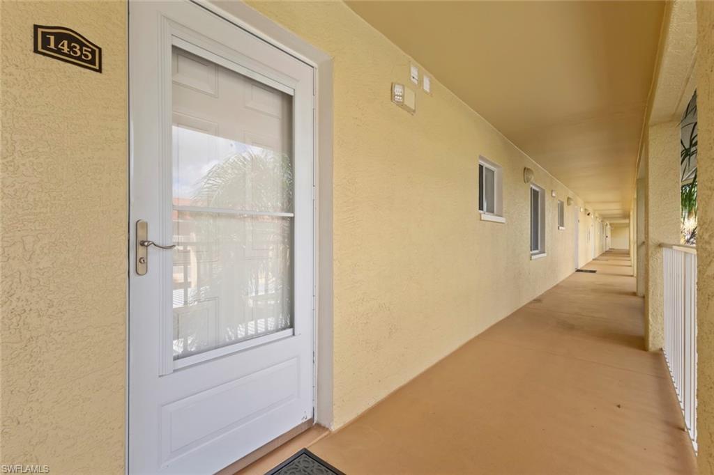 8288 Key Royal Lane, Unit 1435 Naples, FL 34119 - Photo 5 of 26 a view of a hallway with wooden floor