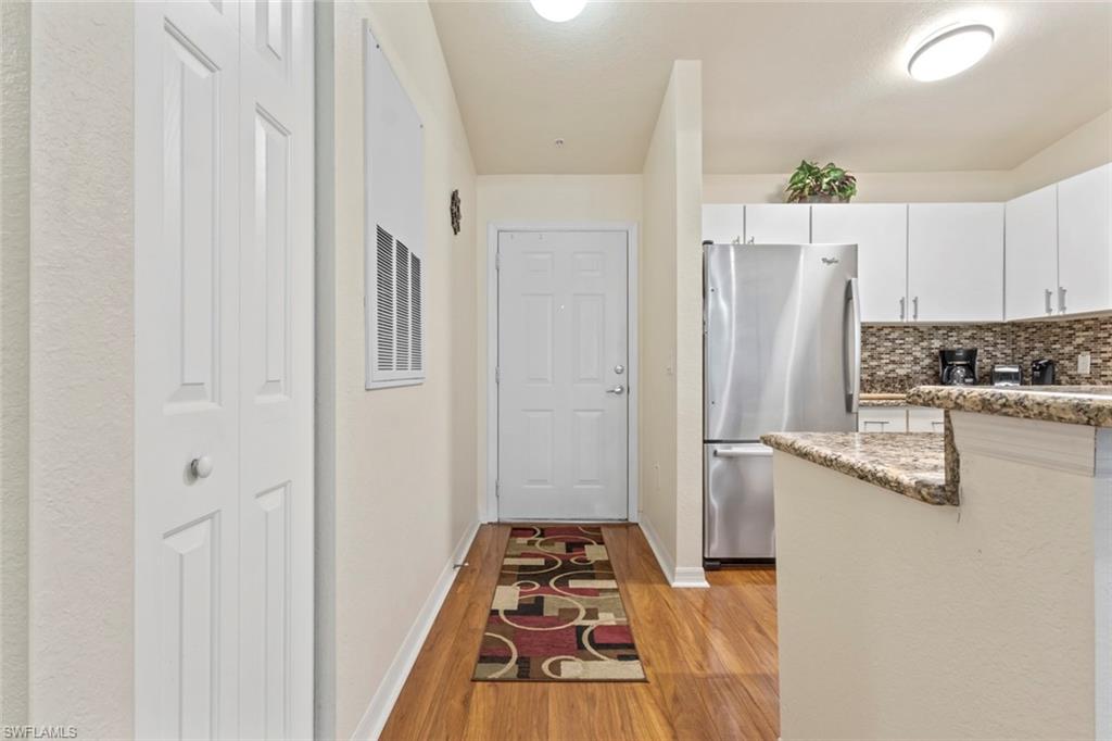8288 Key Royal Lane, Unit 1435 Naples, FL 34119 - Photo 6 of 26 a kitchen with stainless steel appliances a refrigerator and a stove