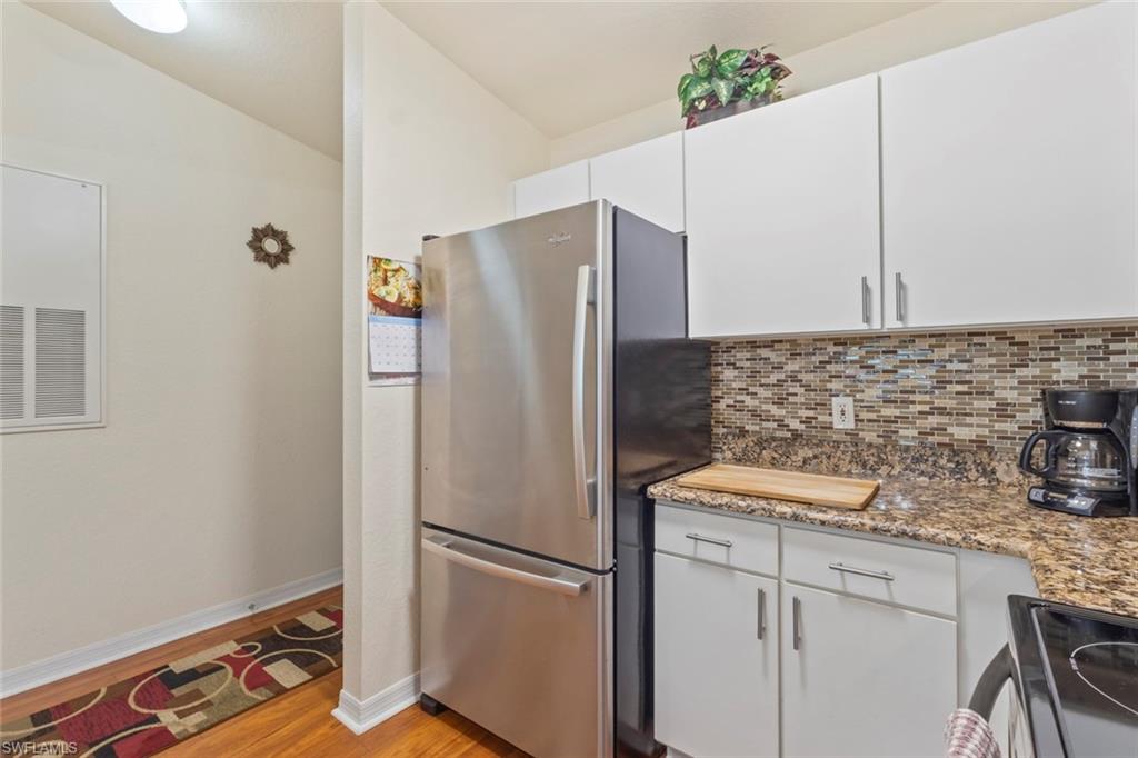 8288 Key Royal Lane, Unit 1435 Naples, FL 34119 - Photo 10 of 26 a white refrigerator freezer sitting inside of a kitchen