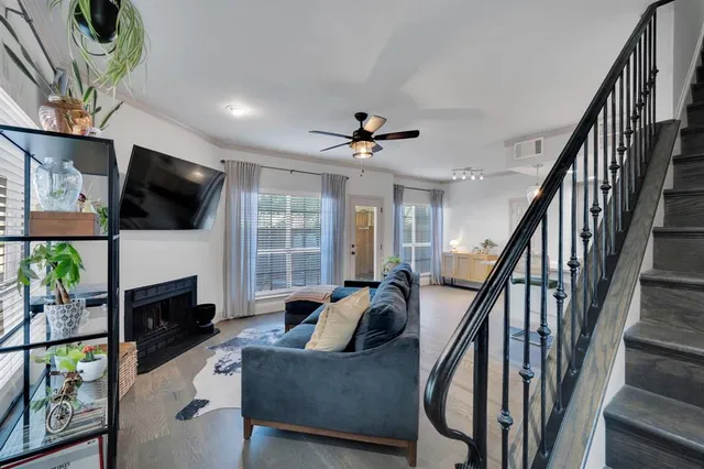 a living room with fireplace furniture and a flat screen tv