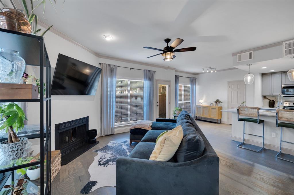 5619 Preston Oaks Road, Unit 802 Dallas, TX 75254 - Photo 16 of 27 a living room with furniture a flat screen tv and a fireplace