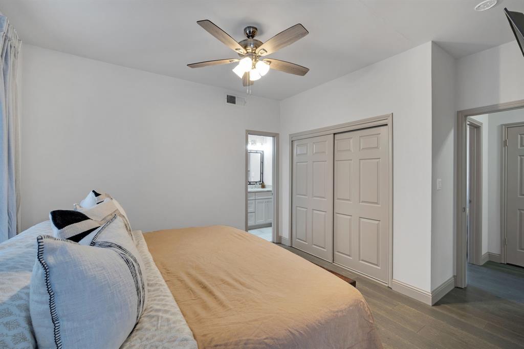 5619 Preston Oaks Road, Unit 802 Dallas, TX 75254 - Photo 17 of 27 a bedroom with a bed and a chandelier